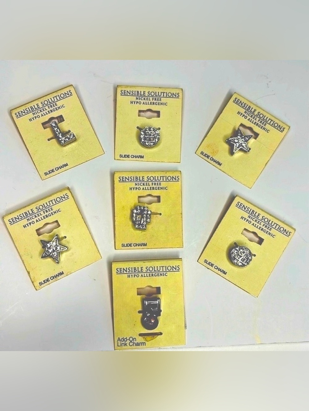 CHARMS (SIX SLIDE ON CHARMS AND ONE ADD ON CHARM)